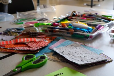 Materials for zine construction: paper, coloring pens and scissors
